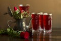 Red rose sorbet in crystal glasses with old metal accessory and fresh red roses on wooden table Royalty Free Stock Photo