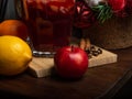 Fragrant spicy traditional drink in a glass goblet, mulled wine, with a Christmas tree, spices and fresh fruits Royalty Free Stock Photo