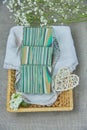 Fragrant striped handmade soap in a wicker basket on a white napkin Royalty Free Stock Photo