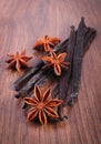 Fragrant vanilla and star anise on wooden surface plank