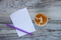 A fragrant vitamin herbal tea with white lilac flowers and a sheet of clean white checkered paper with a purple pencil on a wooden Royalty Free Stock Photo