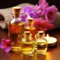 Fragrant yellow massage oil in transparent bottles and beautiful flowers in the spa