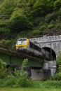 Fraight train in Belgium crossing mountain and bridge