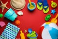 Frame of beach ball and sand toys on red background, flat lay. Space for text Royalty Free Stock Photo