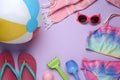 Frame of beach ball, toys and accessories on violet background, flat lay. Space for text Royalty Free Stock Photo