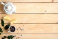 Frame or border of cup of herbal tea, white teapot, lemon and green leaves, view from above, flat lay style composition with free Royalty Free Stock Photo