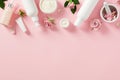 Frame border made of natural cosmetics and skincare beauty products on pink background. Flat lay, top view Royalty Free Stock Photo