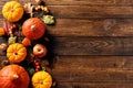 Frame border of pumpkins, fall leaves, berries, apple on wooden table. Thanksgiving, Halloween, Autumn, Harvest concept. Flat lay Royalty Free Stock Photo