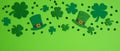 Frame border of shamrock, four leaf clovers and Irish elf hats on green background. Happy St. Patrick`s Day concept Royalty Free Stock Photo