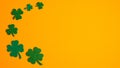 Frame border of shamrock four leaf clovers on orange background. Happy Saint Patrick s day concept. Greeting card, party Royalty Free Stock Photo