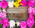 Frame bouquet of pink and white peonies flowers close-up on wooden retro background with copy space. Royalty Free Stock Photo