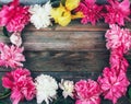 Frame bouquet of pink and white peonies flowers close-up on wooden retro background Royalty Free Stock Photo