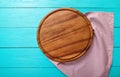 Frame of brown round cutting board on polka dots tablecloth. Blue wooden table in the cafe. copy space Royalty Free Stock Photo