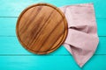 Frame of brown round pizza cutting food board on polka dots tablecloth. Blue wooden background in restaurant. copy space. Mock up. Royalty Free Stock Photo