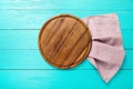 Frame of brown round pizza food cutting board on polka dots tablecloth. Blue wooden background in the restaurant. copy space Royalty Free Stock Photo