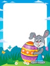 Frame with bunny holding big Easter egg Royalty Free Stock Photo