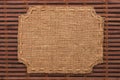 Frame of burlap, lies on a background of bamboo mat