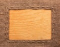 Frame of burlap, lies on a background of wood Royalty Free Stock Photo