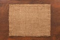 Frame of burlap, lies on a background of wood Royalty Free Stock Photo