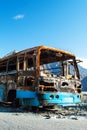 The frame of the burnt bus on the mountain road in Pakistan Royalty Free Stock Photo