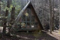 An a frame cabin deep in the mountains with a deck