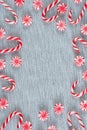 Frame of Christmas candy canes and peppermint swirl candies with copy space