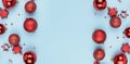 Frame from Christmas red balls on a blue background. Christmas background. New Year`s banner. Copy space Royalty Free Stock Photo