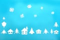 Frame made of white paper figures - houses, Christmas trees, snowflakes on a blue background