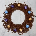 Frame of close up colourful coffee capsules with roasted grains on concrete Royalty Free Stock Photo