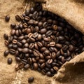 Frame Coffee beans scattered on rough sacking for a rustic feel Royalty Free Stock Photo