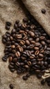 Frame Coffee beans scattered on rough sacking for a rustic feel Royalty Free Stock Photo