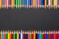 Frame of colored pencils in row isolated on black cardboard Royalty Free Stock Photo