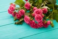 Frame of colorful roses on blue wooden background. Top view and selective focus. Copy space and mock up, Valentine and mother day