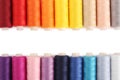 Frame of colorful sewing threads on white background, flat lay. Space for text Royalty Free Stock Photo