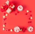 Frame with cupcakes cream cheese frosting decorated with heart candy, macaroons, gift box. Valentines day concept. Top Royalty Free Stock Photo