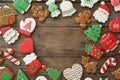 Frame of different Christmas cookies on wooden table, flat lay. Space for text