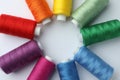Frame of different colorful sewing threads on white background, top view. Space for text Royalty Free Stock Photo