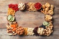 Frame of different dried fruits and nuts on wooden background, top view. Royalty Free Stock Photo