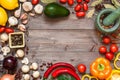 Frame of different fresh organic vegetables and spices on wooden table. Healthy natural food background with copy space. Royalty Free Stock Photo