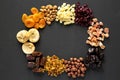 Frame of dried fruits and nuts on a black background, top view. Overhead, from above, flat lay Royalty Free Stock Photo