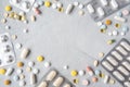 Frame of drugs and pills on a light background. Multi-colored pills, capsules, vitamins laid out in the form of gray on a blue Royalty Free Stock Photo