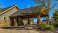 Frame Exterior of a home with view of the paved driveway and pavilion at the entrance