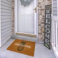 Frame Facade of home with a leafy wreath hanging between the glass and wooden door Royalty Free Stock Photo