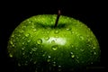 A Frame filling Macro image of a vibrant Green Granny Smith apple covered in water drops beading on the peel Royalty Free Stock Photo