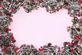 Frame of fir branches, red berries, balls, pine cones, Christmas decoration on pink background. Merry Christmas composition, New Royalty Free Stock Photo