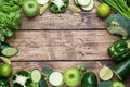 Frame Fresh green vegetables and herbs on a wooden background. Copy space Royalty Free Stock Photo