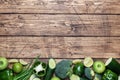 Frame Fresh green vegetables and herbs on a wooden background. Copy space Royalty Free Stock Photo