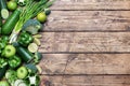 Frame Fresh green vegetables and herbs on a wooden background. Copy space Royalty Free Stock Photo
