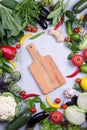 Frame of fresh organic vegetables on a gray concrete background . Healthy natural food top view, copy space Royalty Free Stock Photo