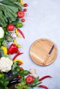 Frame of fresh organic vegetables on a gray concrete background . Healthy natural food top view, copy space Royalty Free Stock Photo